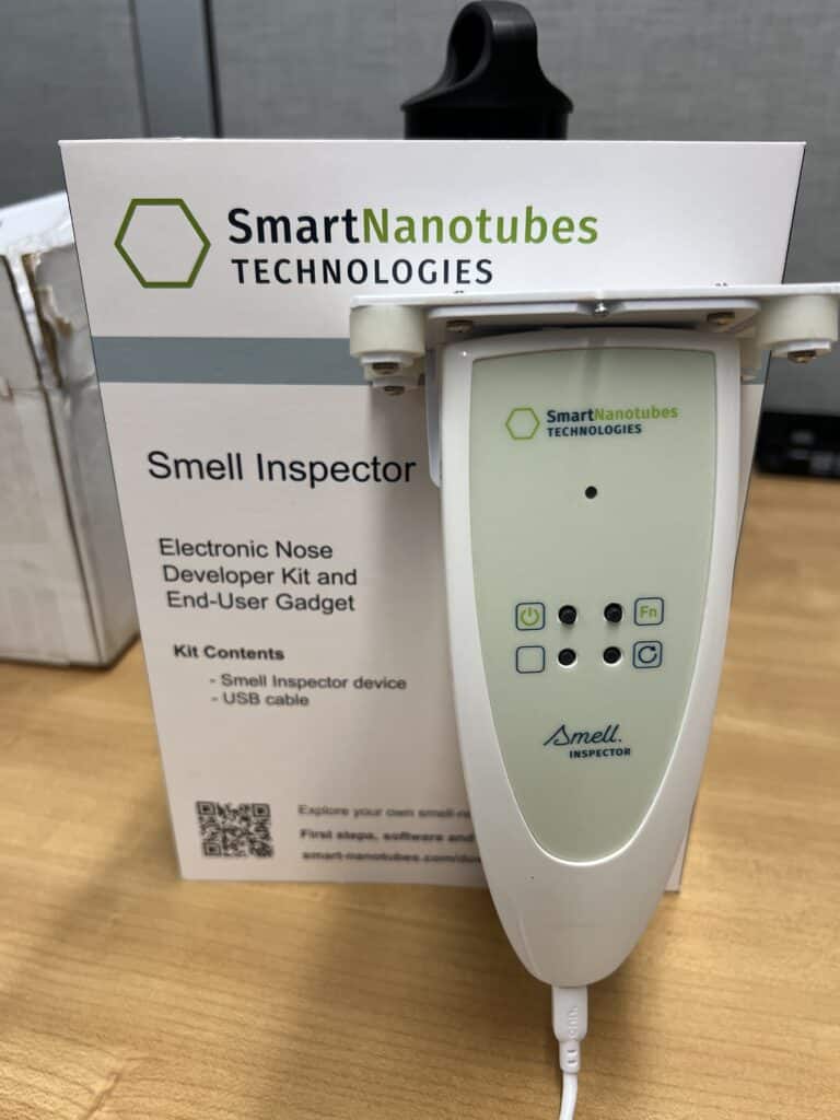 smell inspector device next to its box